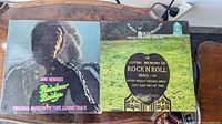 Front covers of two vinyl LP albums: Jimi Hendrix Rainbow Bridge and John Entwistle Rigor Mortis Sets In.