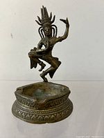 Front and side view of the antique bronzed metal incense burner, showing detailed Shiva figure and base design.