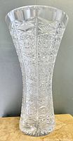 Full front view of the tall, clear Bohemian crystal vase showing detailed brilliant cut pattern on the body and scalloped rim.