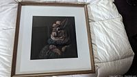 Framed print of anthropomorphic lady rabbit in Victorian garb viewed fully upright on bed.