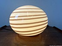 Front view of illuminated lamp on wooden surface