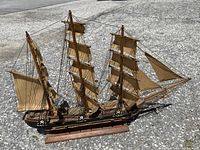 Clear outdoor photo of full ship model with all masts and sails visible from a slightly front angle.