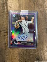 Front view of Dustin May Bowman Chrome Purple Refractor Rookie card with autograph and serial number 225/250 in protective case.