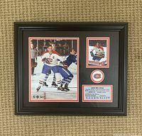 Photo of framed Jean Beliveau wall art showing a large action shot, a smaller hockey card, Montreal Canadiens logo, and text plaque.