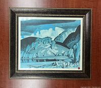 Full view of the framed limited edition print showing a blue and teal rocky landscape with water and sky.