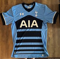 Front view of the Tottenham Hotspur soccer jersey showing sponsor, team logo, and color pattern.