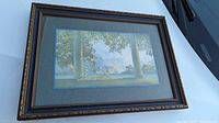 Photo of framed Maxfield Parrish art print showing overall front view of frame and art titled "Daybreak" with nude figure and columns.