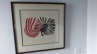 Full view of framed print leaning against wall