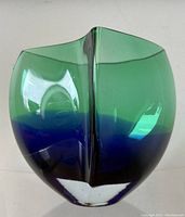 Front view of ovoid art glass vase showing horizontal green and blue colors and smooth glossy finish.