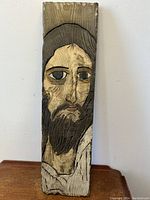 Front view of the hand carved wood sculpture depicting Jesus Christ's face and upper body.