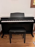 Front view of Roland digital piano with bench