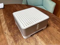 Top and side view of the Sonos ZonePlayer 120 amplifier showing white perforated top and volume control buttons on the side.