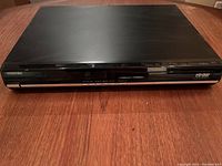 Front view of the Toshiba HD DVD player showing brand label, display, and control buttons.