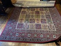 IKEA Valby Ruta rug partially rolled showing the underside and detailed pattern