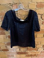 Front view of dark blue-black silk top with square velvet neckline.