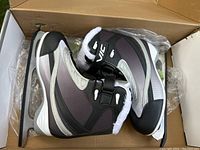 Pair of women's VIC figure skates size 5 inside their original box, showing black, silver, and white color scheme with white faux fur lining.