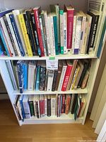 Photo showing full bookshelf with all three levels filled with books related to psychology, self-help, and social justice topics