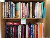 Books on two shelves showing titles on writing, women's issues, Tarot, I Ching, and creative nonfiction.