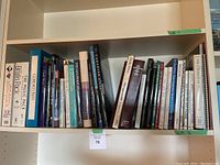 Bookshelf with art and coffee table books, including The Far Side and Calvin & Hobbes titles.