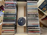 Photo showing the full assortment of CDs stacked in groups on a table.