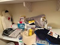 Wide shot of assorted first aid supplies including blood pressure cuff, Magic Bag heating pad, pill sorters, bandages, and various medical items.