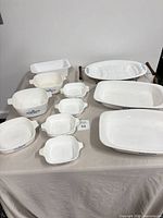 All eleven CorningWare pieces arranged on table