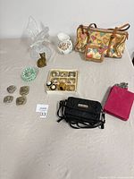 Group shot showing handbag, ID purse, crossbody bags, jewelry tray, bracelets, figurines and pitcher