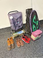Group shot showing cart, golf bag, boxed tent, footwear, putting partner box