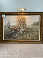 Full view of framed hunt scene painting with riders and hounds