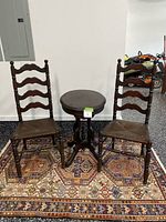 Two ladder back chairs, pedestal table and rug