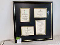 Overall framed display showing four invitations