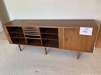 Front view showing entire buffet with three compartments and tapered legs