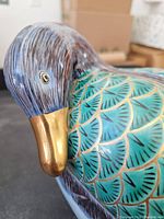 Close-up of duck head showing detailed handpainted brush strokes and gold-colored beak