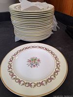 Stack of 20 Wedgwood Sandringham 8 inch salad plates with floral and gold scroll border design.