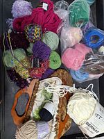 Top view of assortment of yarn skeins including novelty and standard types, showing vibrant colors and textures packed together