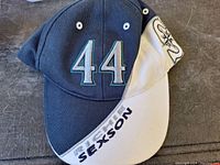 Close-up of front of navy and white Seattle Mariners baseball hat with #44 and 'SEXSON' embroidered on brim