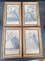 Four framed antique Les Modes 1861 fashion prints showing women in 19th century dresses.