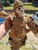 Close-up of the full marionette showing costume details and materials.