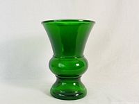 Front view of large vintage emerald green glass vase showing smooth, glossy surface and shape