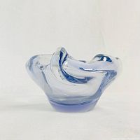 Front view of mid century modern sky blue art glass bowl on a white background, showcasing its organic form and smooth glass finish.