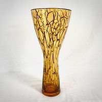 Full view of the tall amber glass vase showing its textured crackle pattern and flared shape.