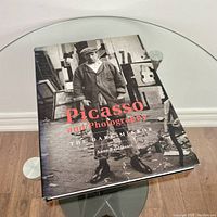 Front cover of Picasso and Photography: The Dark Mirror showing a black and white image of Picasso in studio with red and white lettering.