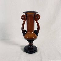 Full view of the vintage amber glass vase displaying its shape and color on a white background.