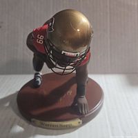 Front close-up showing Warren Sapp figurine in defensive pose with helmet and uniform details.
