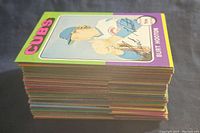 Stack of vintage baseball cards showing multicolored borders and ‘CUBS’ card on top