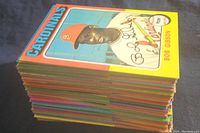 Stack of vintage Topps baseball cards viewed from side, showing varied border colors and edge wear
