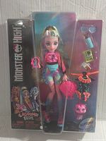 Front view of the Monster High Lagoona Blue doll in original packaging, showing doll, accessories, and pet Neptuna.