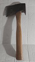 Full view of the vintage Tommy Axe hatchet showing wooden handle and black metal head.