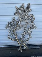Full view of the Syroco cherry blossom metal wall art depicting a tree with detailed branches and flowers against a white background.