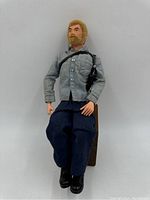 Full body photo of the 12-inch GI Joe figure dressed in shirt, pants and boots with black shoulder harness accessory